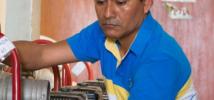 Miguel Siesquen is cleaning water pumps for use in flood emergencies in Illimo, Peru. 